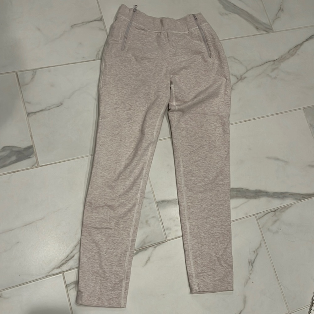 Lululemon size 4 cream sweats with front zipper pocket.